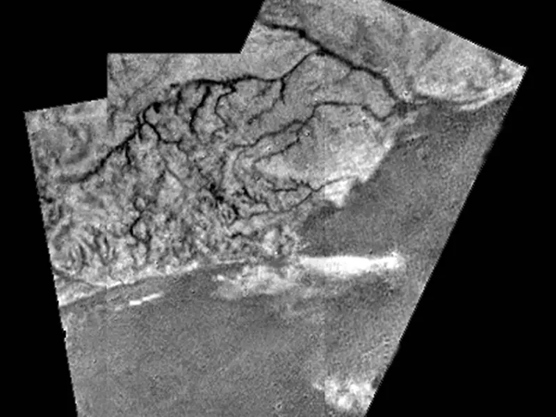 A grey landscape seen from above, with high ground and a channel running down it