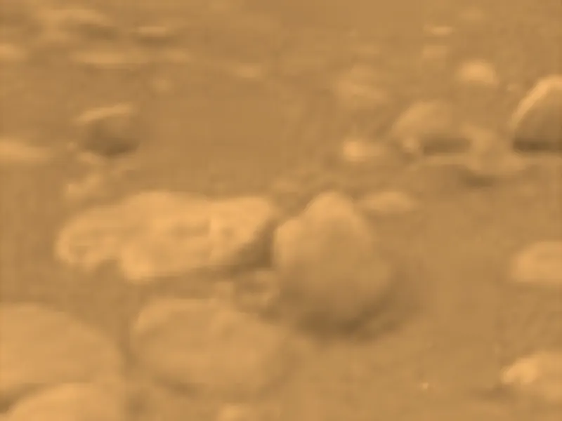 A flat orange plain scattered with rounded pebbles