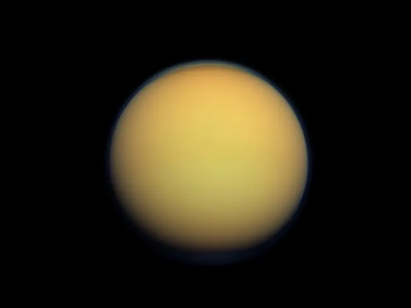 A fuzzy orange moon wrapped in thick haze