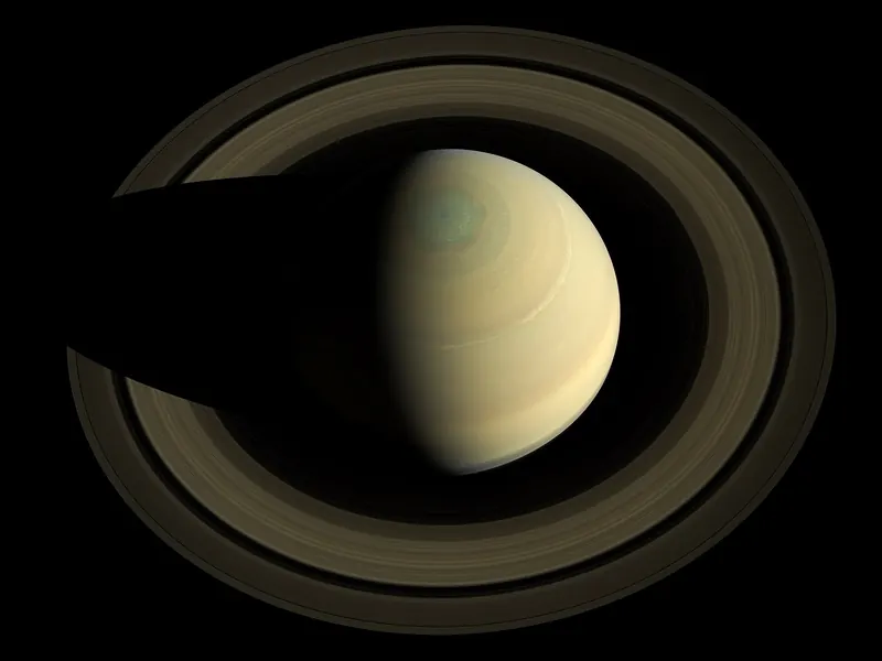 Saturn seen from above its north pole, with its rings spread out around it like a vinyl record